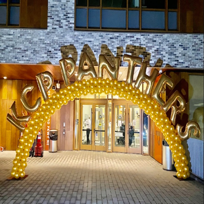 black and gold balloon arch